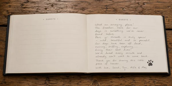 A handwritten guest book entry from Holiday With Your Dogs detailing a dog-friendly stay with mention of "freedom for our dogs" and "living their best lives."