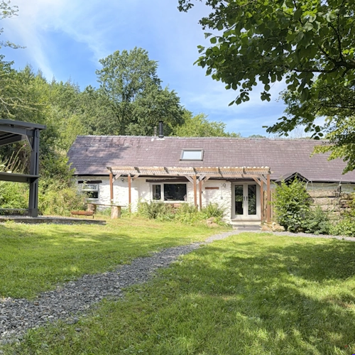 Outside view of our holiday cottage with a 1.8m fenced, secluded garden for reactive and anxious dogs.